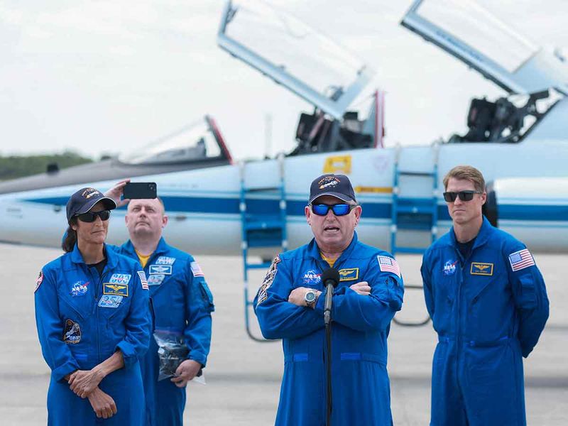 NASA’s Boeing Crew Flight Test Commander Butch Wilmore (C) and Pilot Suni Williams (L) address the media after arriving at the Kennedy Space Center on April 25, 2024 in Cape Canaveral, Florida.