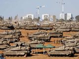 Israeli soldiers stand next to military vehicles, amid the ongoing conflict between Israel and the Palestinian Islamist group Hamas, near the Israel-Gaza Border, in southern Israel, May 7, 2024. 