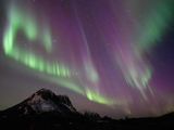 This picture shows northern lights (Aurora Borealis) over the mountain at Utakleiv on March 3, 2024 in Lofoten Islands. A huge solar storm is heading for Earth, supercharging auroras and bringing possible disruptions to satellites and power grids as early as the evening of May 10, 2024, US officials say. 