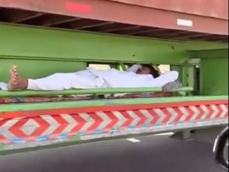 Watch: Man spotted sleeping under speeding truck