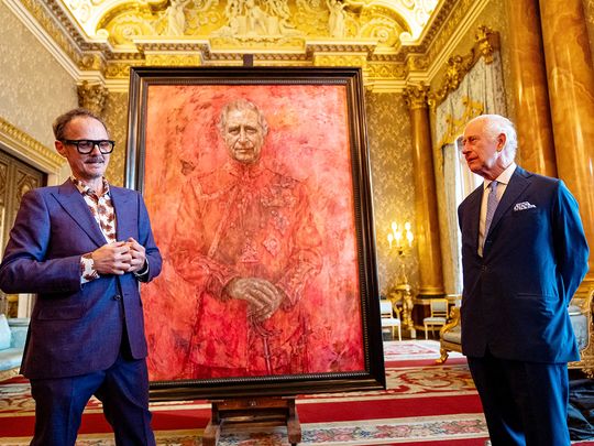 Britain's King Charles meets with artist Jonathan Yeo next to a portrait of the king