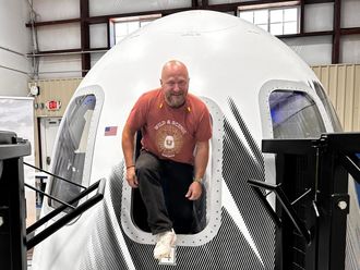 This undated photo provided by North Communication shows French entrepreneur Sylvain Chiron emerging from the Blue Origin space capsule in Van Horn, Texas. 