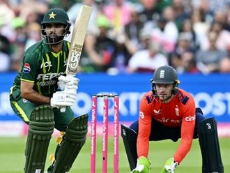 Pakistan batsman Fakhar Zaman in action, watched by England captain Jos Buttle