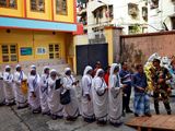 People wait outside a polling station to vote during the seventh and last phase of India's general election in Kolkata, India, June 1, 2024