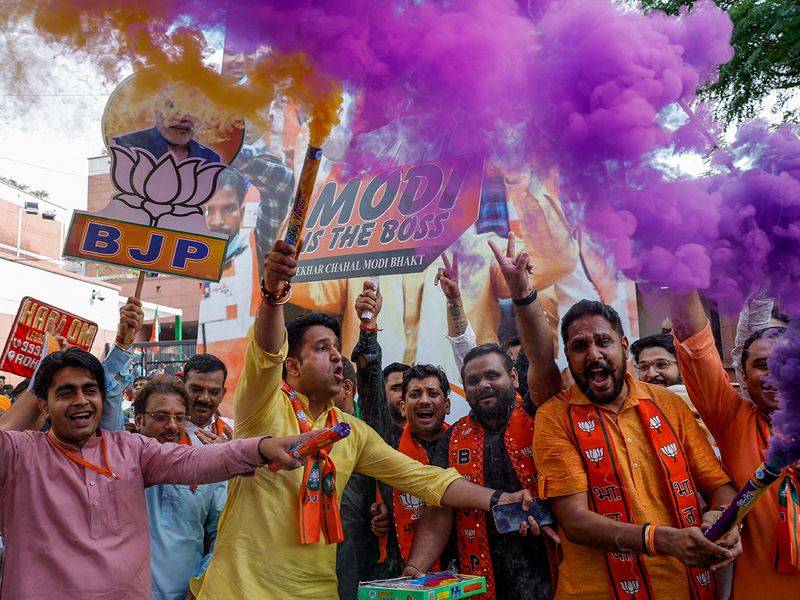 Bharatiya Janata Party (BJP) supporters celebrate outside BJP headquarters, on the day of the general election results, in New Delhi. 