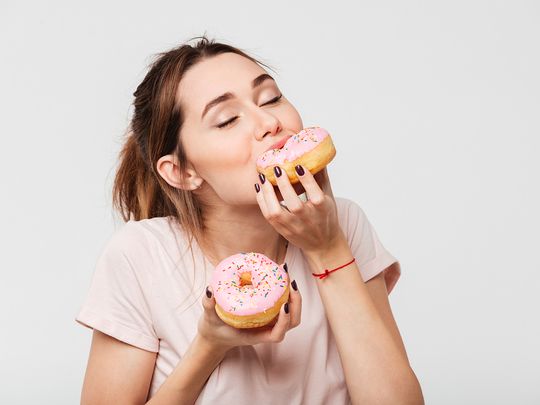 Person eating donuts