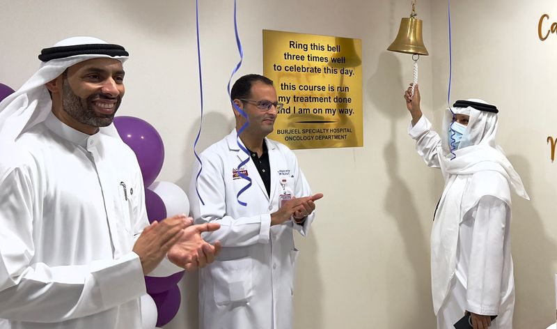 Muhammad Aman Hussein, who recovered from colon cancer, ringing the bell during an event marking Cancer Survivor Month