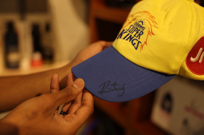 . Signed cricket merchandise like jerseys and caps are displayed like trophies around the shop. 