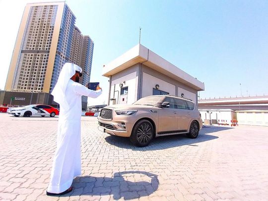 dubai-municipality-official-checks-a-neglected-vehicle-at-a-testing-centre-1720609048137