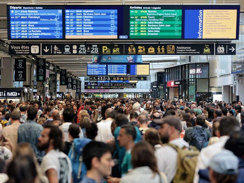  Passengers gather around the departure boards at the Gare Montparnasse train station in Paris 