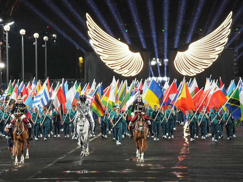 The horsewoman (C) arrive with the Olympic flag at the Trocadero Stadium during the opening ceremony of the Paris 2024 Olympic Games in Paris. 