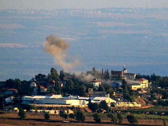 A photo taken from southern Lebanon near the Israeli border shows smoke from a rocket fired