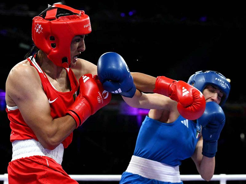 Algeria's Imane Khelif (in red) punches Italy's Angela Carini 