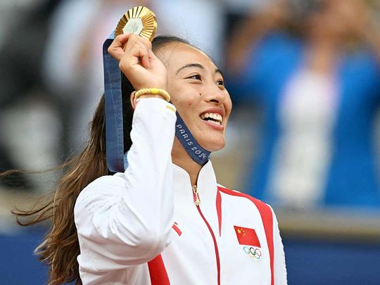 China's Zheng Qinwen poses with her gold medal 