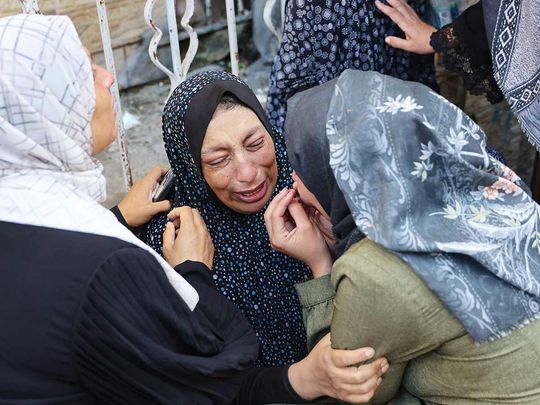 A woman reacts after identifying a member of her family 