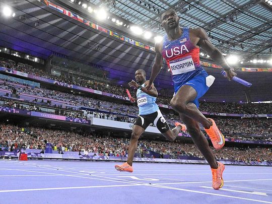 US' Rai Benjamin crosses the finish line 