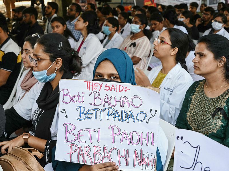 A doctor holds a placard as she takes part in a protest in Hyderabad