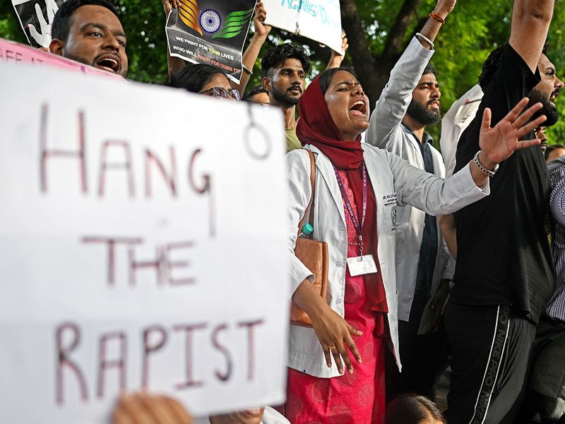 Medical professionals and students shout slogans