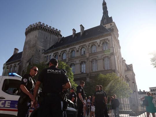 French police stand guard in front of the Town Hall 