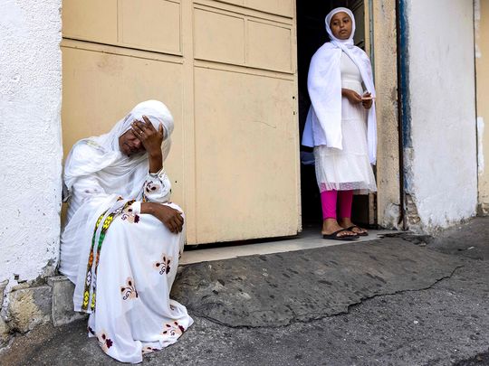 An Eritrean woman reacts 