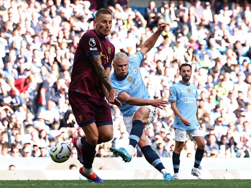 Manchester City's Erling Haaland (C) shoots to score his third goal