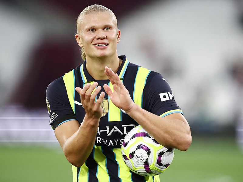 Manchester City's striker Erling Haaland poses with the match ball 