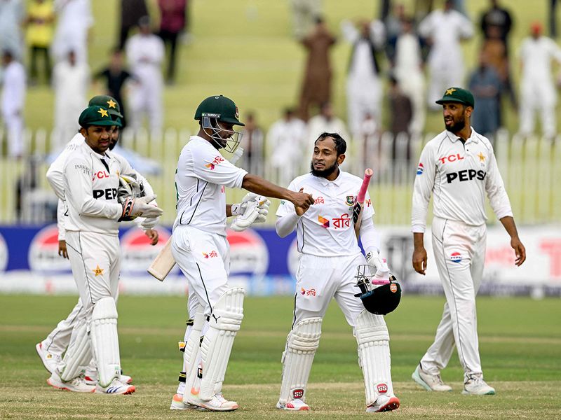 Bangladesh's Mushfiqur Rahim (2R) and Shakib Al Hasan (3R) celebrate