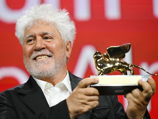 Spanish director Pedro Almodovar poses with the Golden Lion for Best Film