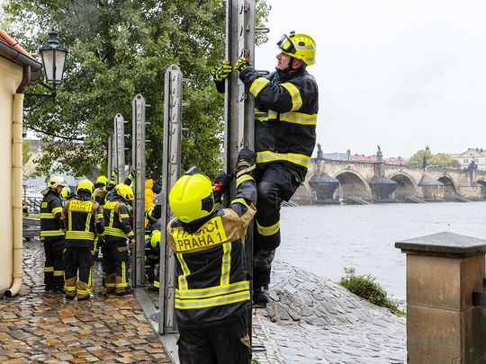 Firefighters build anti-flood barriers on the left bank of the Vlatva river