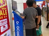 People using a GCash kiosk in the Philippines