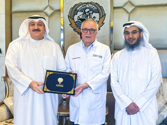 Kuwaiti Health Minister Dr Ahmed Al Awadhi (left) honours Dr Remesh Pandita