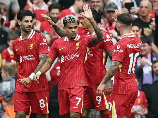 Liverpool's midfielder Luis Diaz (C) celebrates