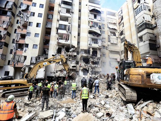 Rescuers sift through the rubble at the scene of an Israeli strike