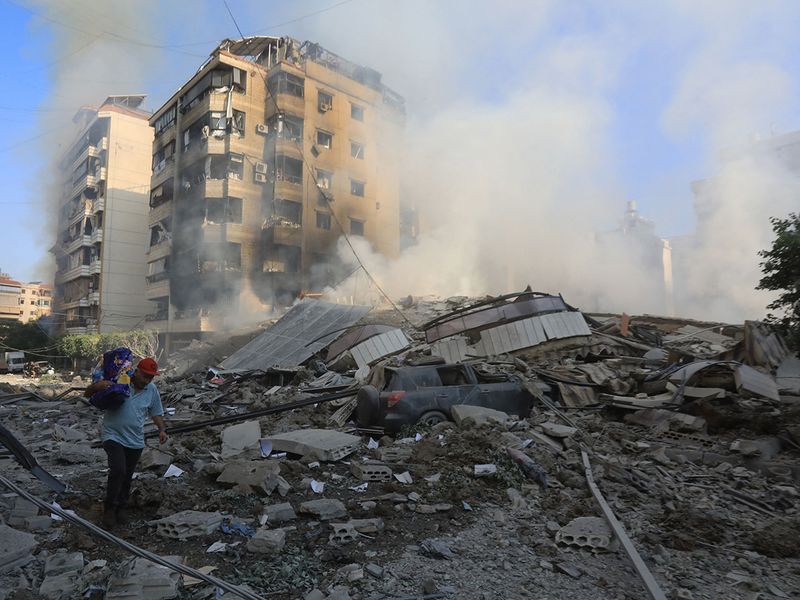 A man walks through the rubble 