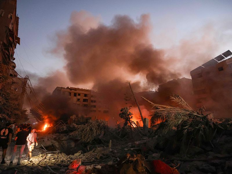 Smoke rises from the smouldering rubble 