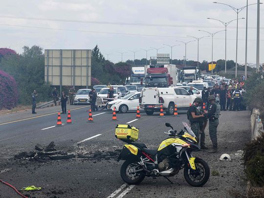 Israeli emergency and security personnel deploy at the impact site 