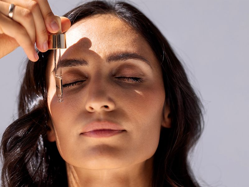 Woman putting serums