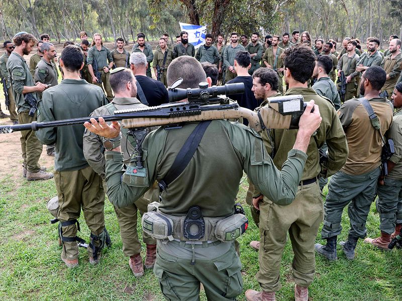 Israeli soldiers gather at the abandoned site of the Supernova music festival 