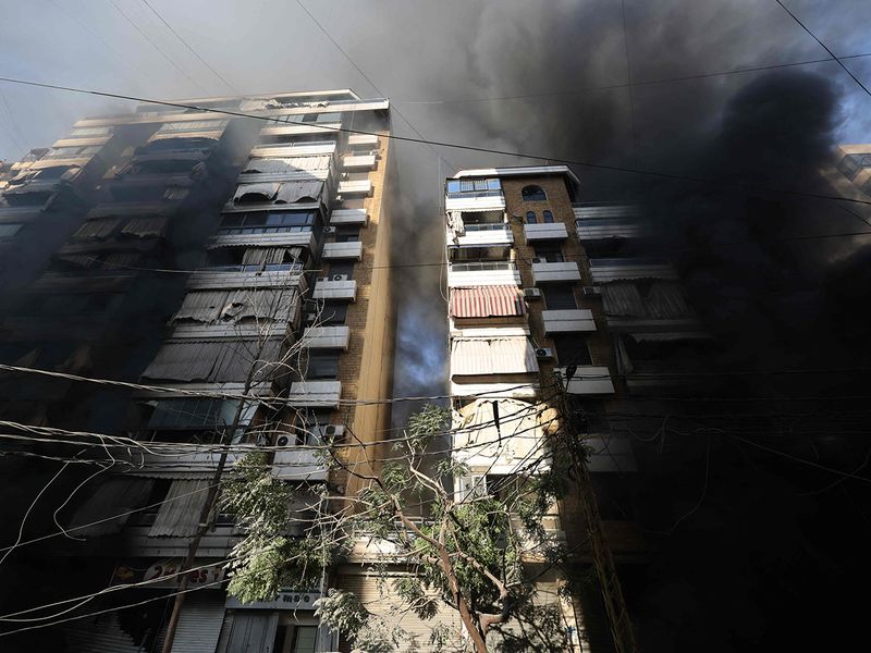 Smoke rises from a building hit by an Israeli airstrike