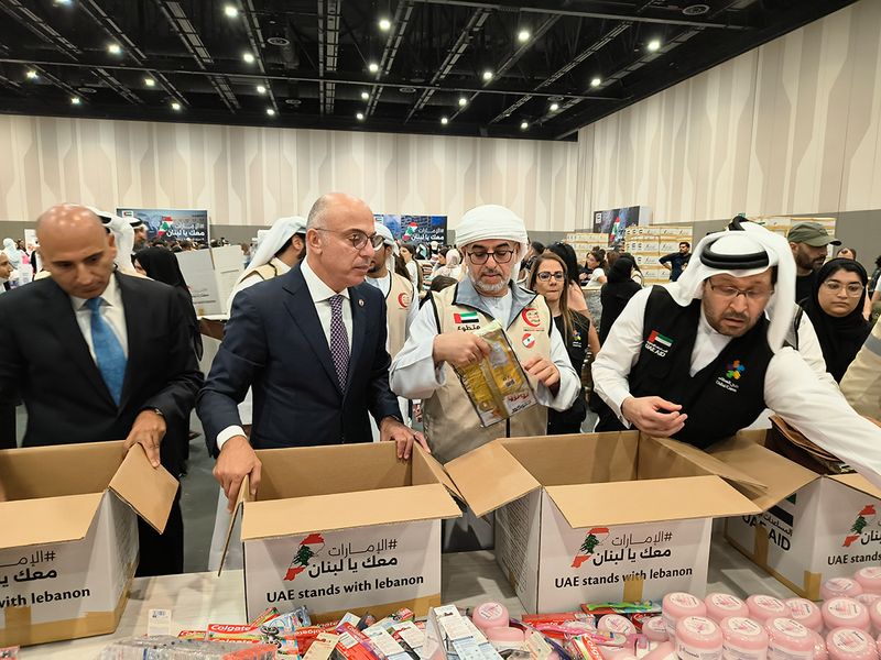 Top officials from the Emirates Red Crescent, Dubai Cares and the Lebanese Ambassador to the UAE, packing the aid boxes