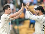 New Zealand's Matt Henry celebrates with his teammate Devon Conway (R)