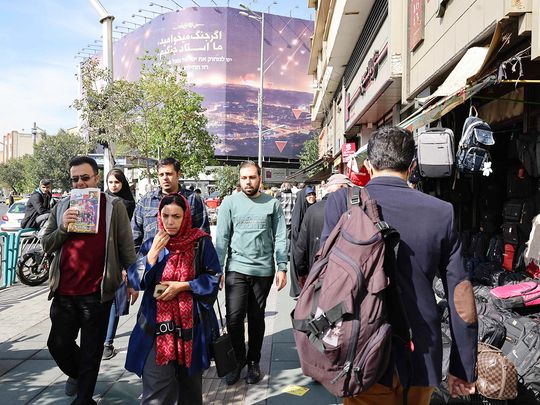 People walk along a street in Tehran 