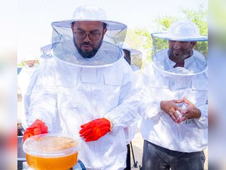 (L) Dr Khalifa Musabah Al Tunaiji, head of Sharjah Agriculture and Livestock Department and CEO of Ektifa, with the first batch of honey from the reserve