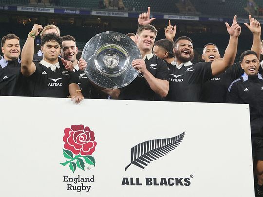 New Zealand's players celebrate with the trophy