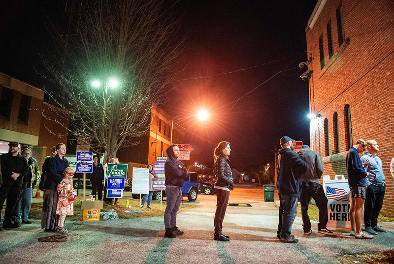 People wait in line to vote in New Hampshire