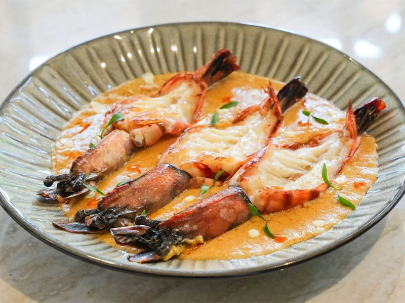 Malai Chingri served at Khadak is a must try for seafood lovers.