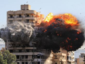 Fire and smoke erupt from a building 