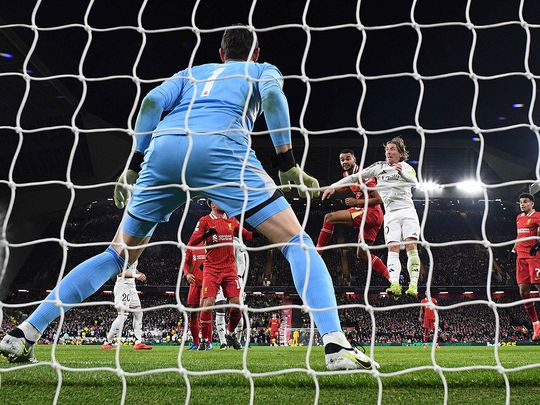 Liverpool's striker Cody Gakpo (C) watches his header in to the net as he scores