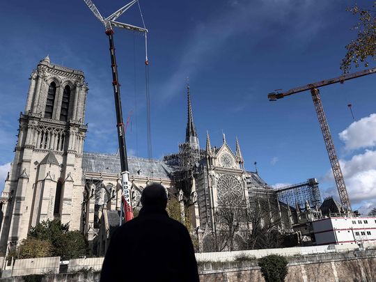 A man looks at Notre Dame de Paris cathedral, in Paris