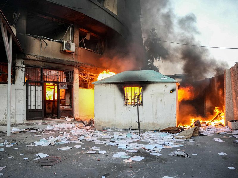 A fire burns after anti-government forces ransacked a government security facility, in Damascus, on December 8, 2024. 